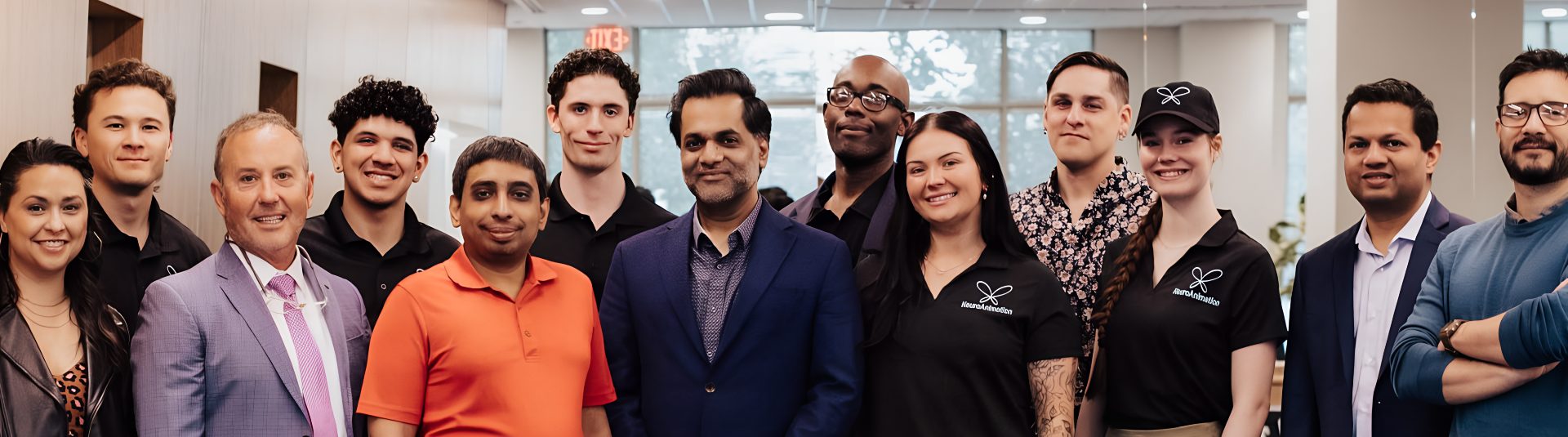The NeuroAnimation team smiling in the office